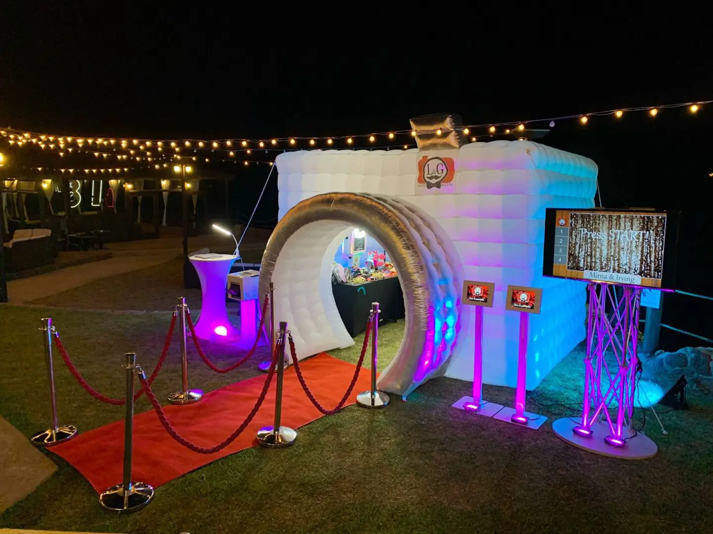 A photo booth set up in the shape of an arch.
