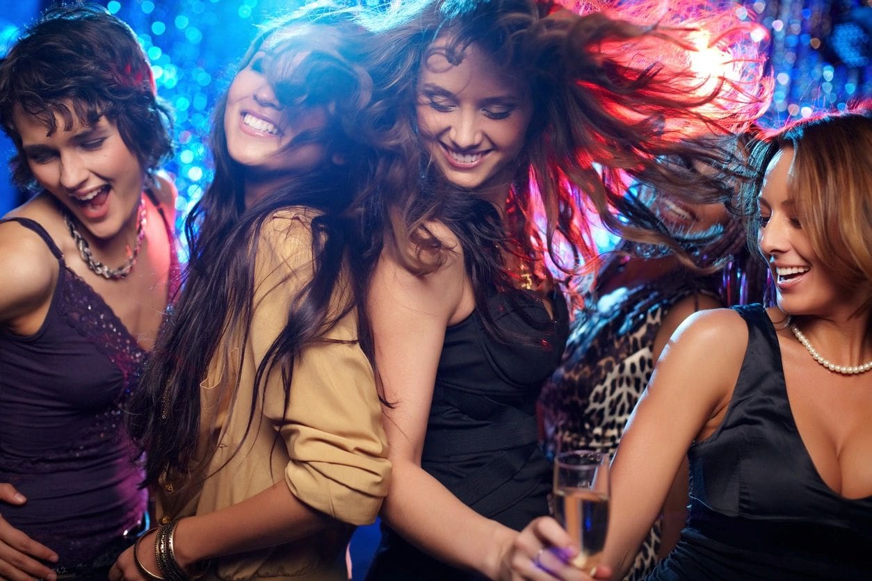 A group of young women dancing in a club.